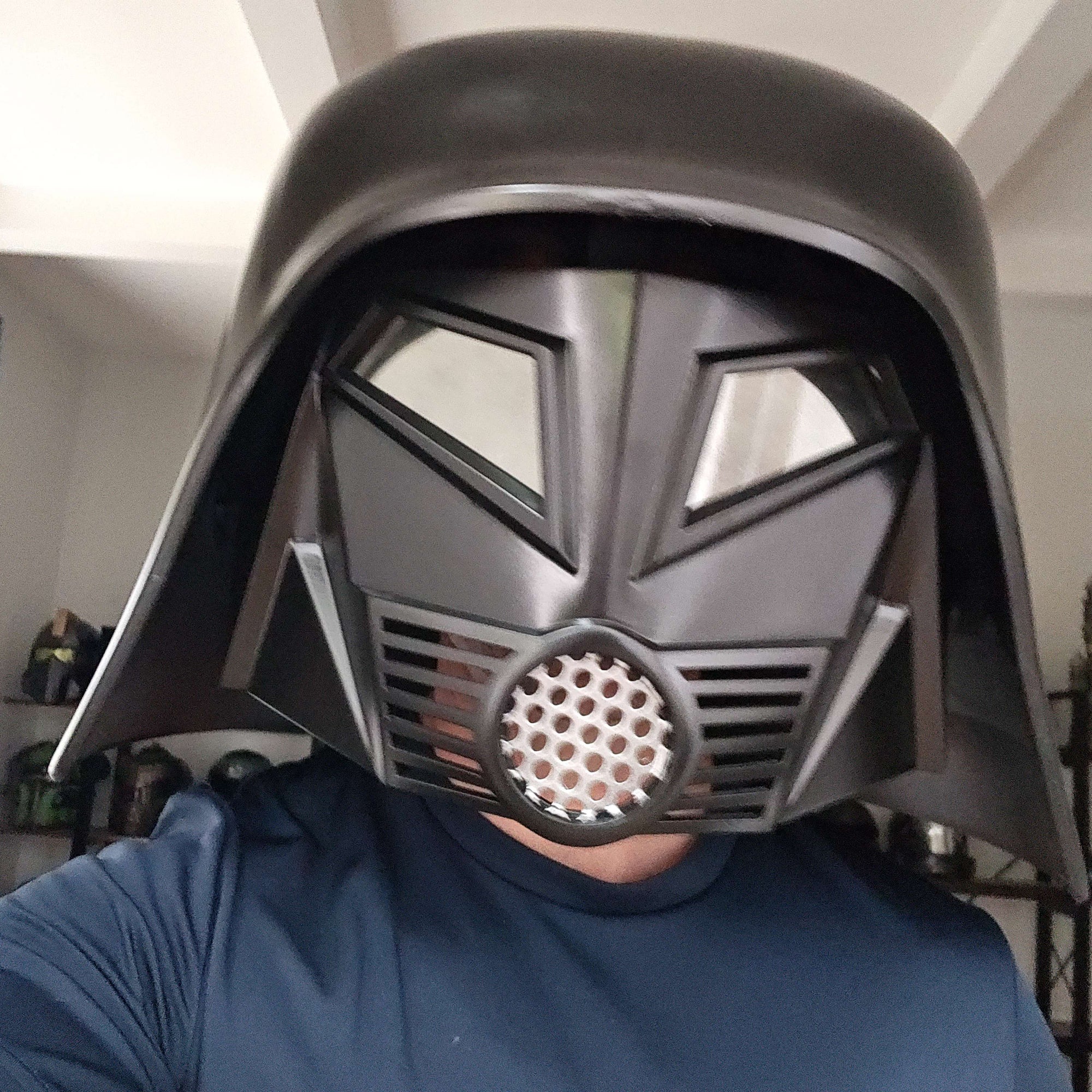 Person wearing a Spaceballs Dark Helmet in an indoor setting