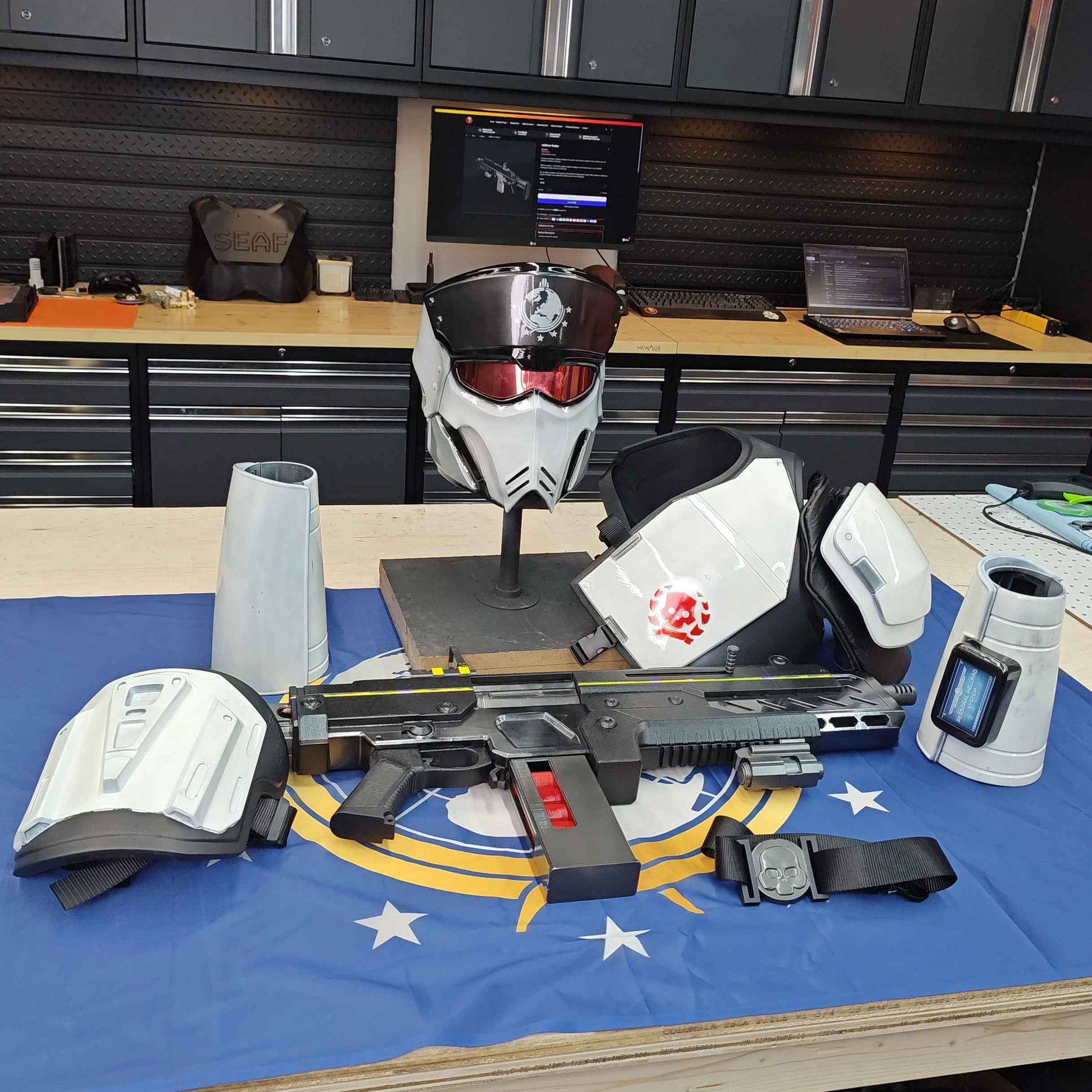 Weapon on a table with a blue flag featuring white stars, in an indoor setting.